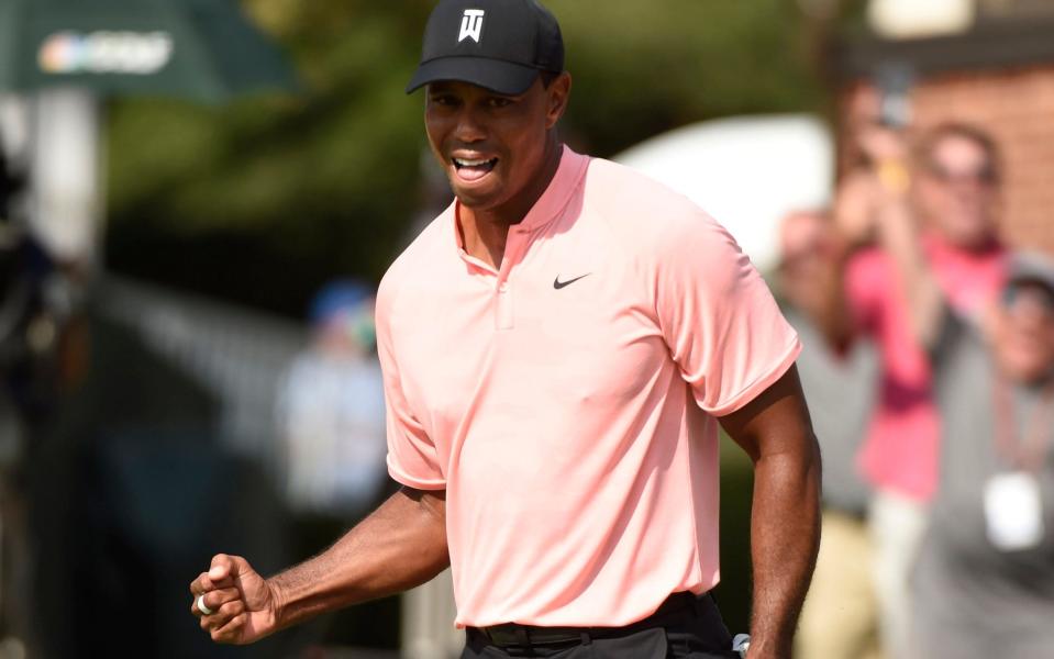 Tiger Woods sunk a 20ft putt for an eagle on the 18th - USA TODAY Sports