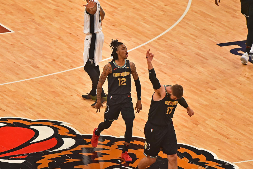 Memphis Grizzlies Ja Morant and Jonas Valanciunas celebrate during the first half of their victory on Thursday. (Justin Ford/Getty Images)