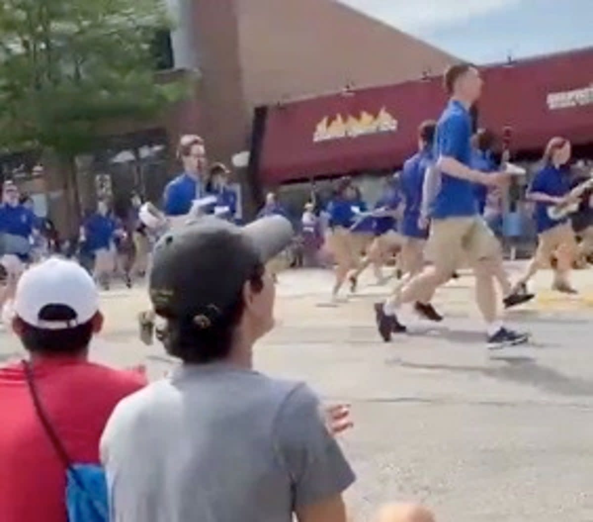 Footage posted online shows revellers and parade participants flee as gunfire erupts (TikTok/Leonarcos11)
