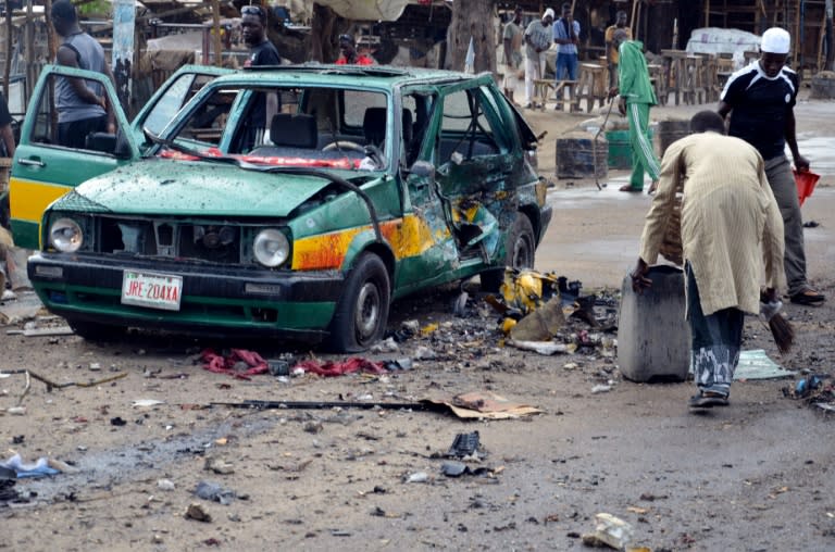 A taxi burned out in the blast pictured in Maiduguri on July 31, 2015 after a female suicide bomber targeted a market in the northeastern Nigerian city