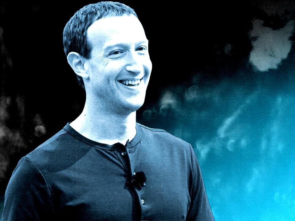 Mark Zuckerberg is smiling.