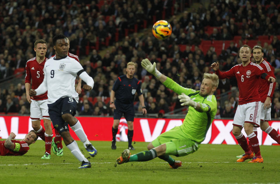 England's Daniel Sturridge, second left, shot is blocked by Denmark's goalkeeper Kasper Schmeichel, third right, during the international friendly soccer match between England and Denmark at Wembley Stadium in London, Wednesday, March 5, 2014. (AP Photo/Sang Tan)