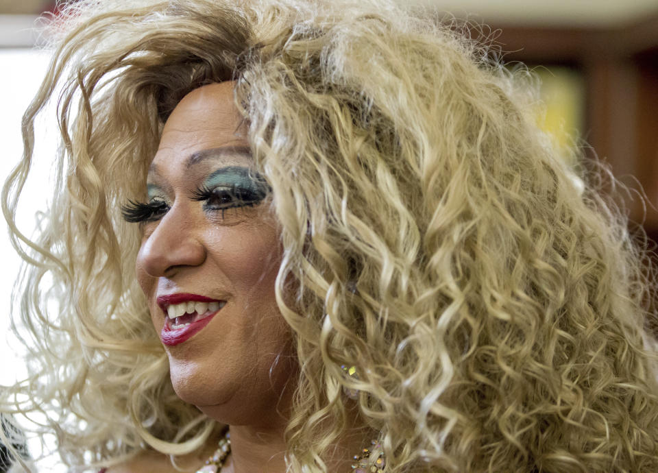 Vanessa Carr reads to children during Drag Queen Story Time at the Alvar Library in New Orleans on Saturday, Aug. 25, 2018. Children and parents and caregivers packed into the library to hear drag queens Blazen Haven and Carr read stories and sing songs during the event. (Scott Threlkeld/The Advocate via AP)