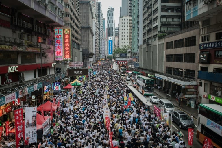 Demonstrators march during a pro-democracy rally seeking greater democracy in Hong Kong on July 1, 2014 as frustration grows over the influence of Beijing on the city