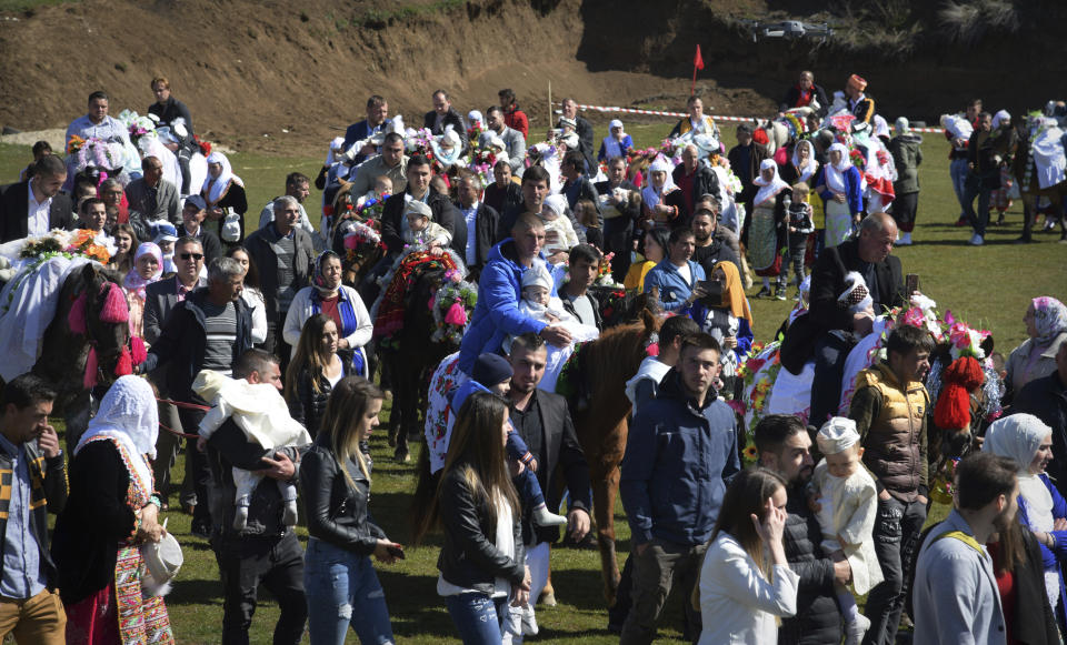 Bulgarian muslims walk in a procession during mass circumcision ceremony in the village of Ribnovo, Bulgaria, Sunday, April 11, 2021. Despite the dangers associated with COVID-19 and government calls to avoid large gatherings, Hundreds of people flocked to the tiny village of Ribnovo in southwestern Bulgaria for a four-day festival of feasting, music and the ritual of circumcision which is considered by Muslims a religious duty and essential part of a man's identity. (AP Photo/Jordan Simeonov)