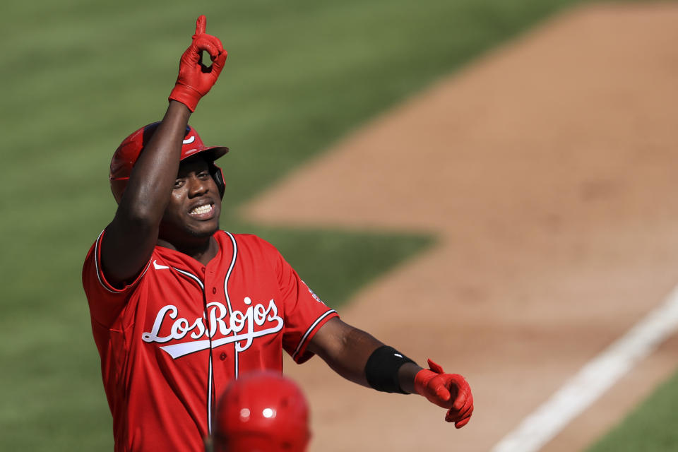 Cincinnati Reds' Aristides Aquino reacts after hitting a two-run home run in the fifth inning during a baseball game against the Chicago White Sox in Cincinnati, Sunday, Sept. 20, 2020. (AP Photo/Aaron Doster)