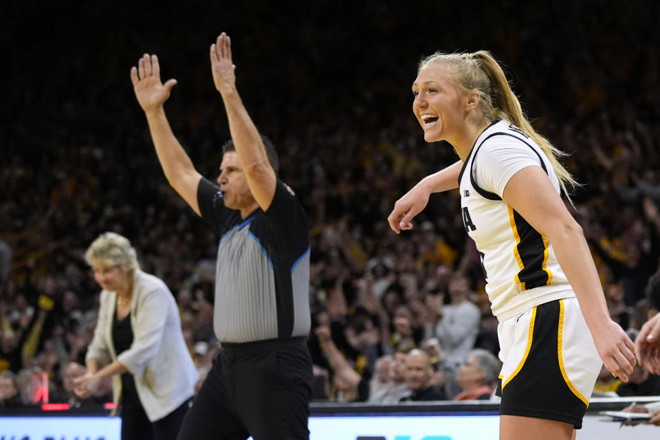 Iowa guard Sydney Affolter, right, celebrates after making a 3-point basket during the second half of an NCAA college basketball game against Penn State, Thursday, Feb. 8, 2024, in Iowa City, Iowa. Iowa won 111-93. (AP Photo/Charlie Neibergall)