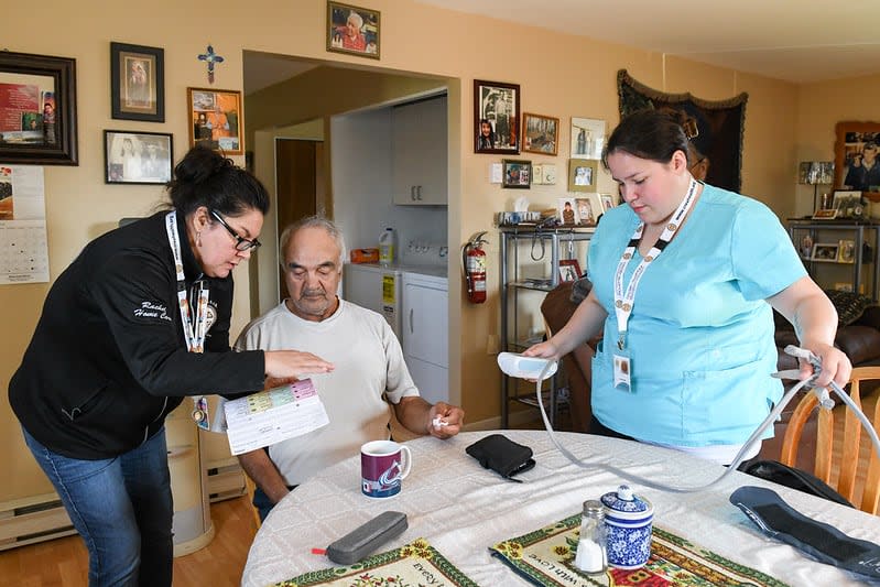 Left, Rachel Danyluk trains nurse, right, Carrie-Lynn Macleod while making a home visit and give patient care. 