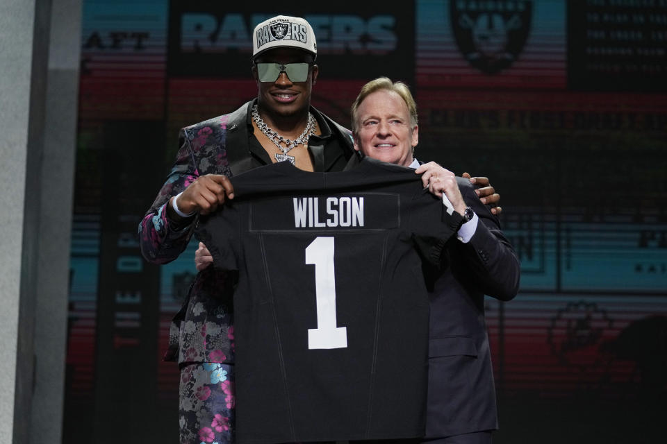 Texas Tech defensive lineman Tyree Wilson, left, poses with NFL Commissioner Roger Goodell after being chosen by the Las Vegas Raiders with the seventh overall pick during the first round of the NFL football draft, Thursday, April 27, 2023, in Kansas City, Mo. (AP Photo/Jeff Roberson)