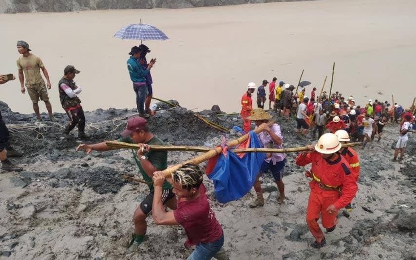 People retrieved dead bodies from the site of the accident - MYANMAR FIRE SERVICES DEPARTMENT/via REUTERS 