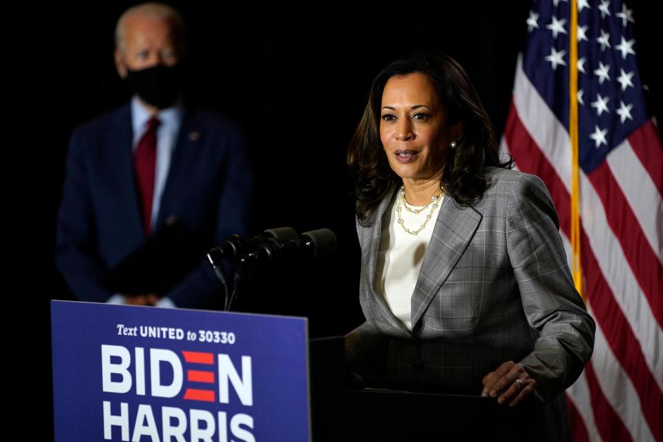 Democratic presidential candidate former Vice President Joe Biden, left, looks on as his running mate Sen. Kamala Harris, D-Calif., speaks at the Hotel DuPont in Wilmington, Del., Thursday, Aug. 13, 2020.