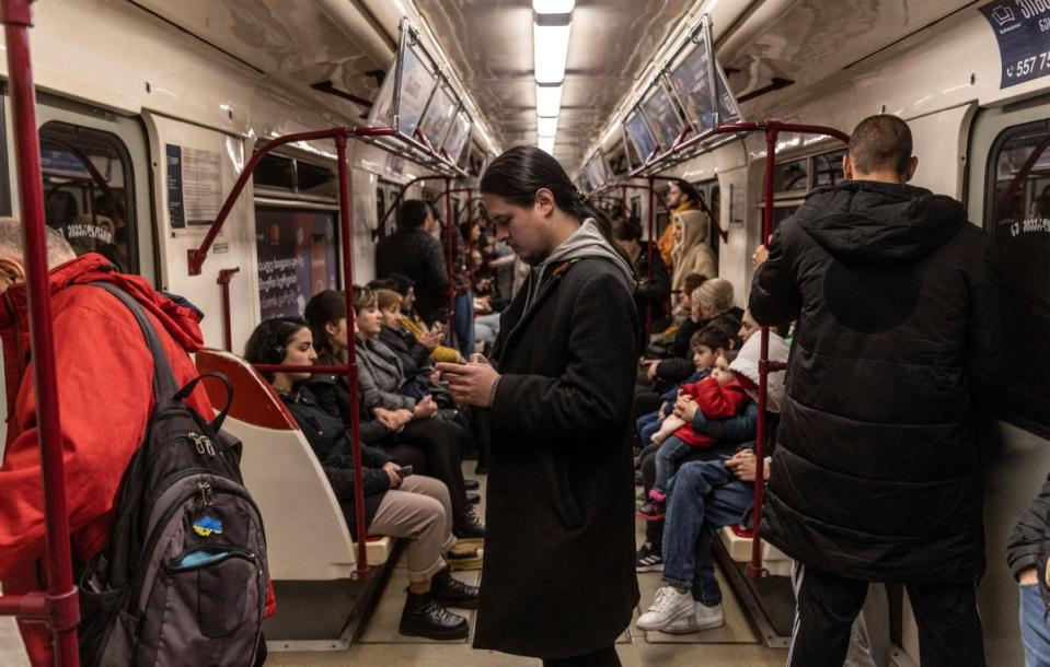 Antropov looks at his phone in the subway (Reuters)