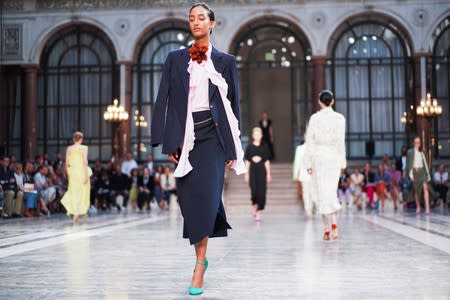 Models present creations during the Victoria Beckham catwalk show at London Fashion Week in London