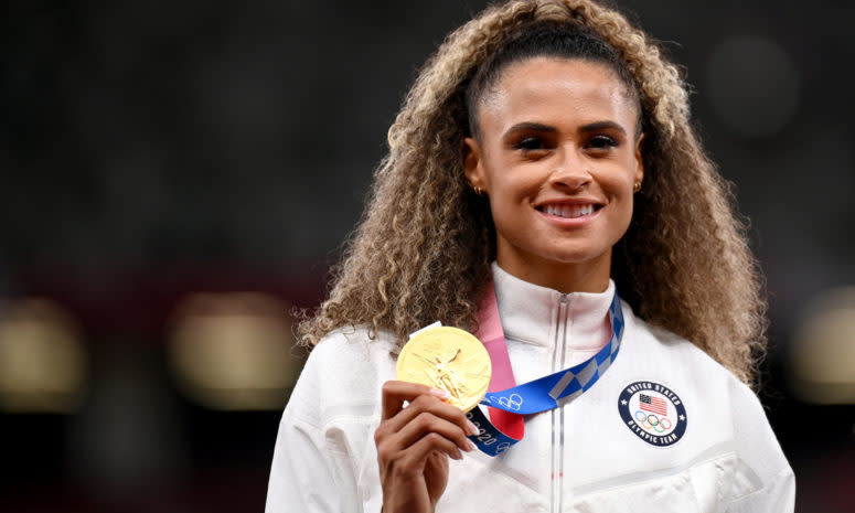 Sydney McLaughlin poses with a gold medal.