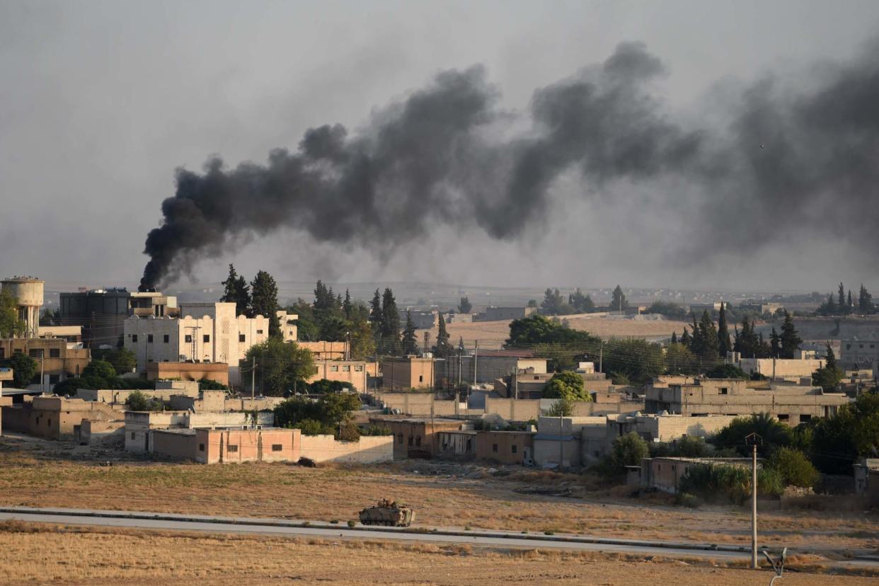 A Turkish army armored vehicle advances in Syrian city of Tel Abyad, as seen from the Turkish border town of Akcakale: Getty Images