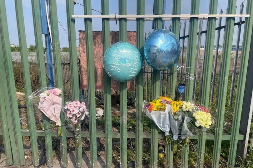 Balloons and flowers left at the site of a fatal crash on Drews Lane, Ward End