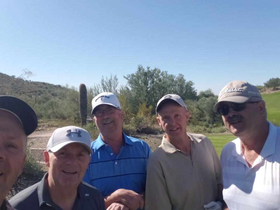 Pat Rowe of Fort Simpson, N.W.T., centre, with some of his golf buddies. Rowe died in April 2024.