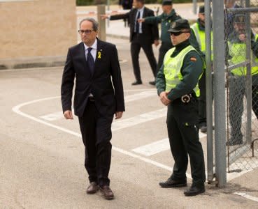 Newly elected Catalan regional leader Quim Torra passes a civil guard, as he leaves the Estremera prison where he visited former Catalan cabinet members Oriol Junqueras, Jordi Turull, Joaquim Forn, Josep Rull and Raul Romeva, who are jailed there, pending trial, on charges of sedition, rebellion and misappropriation of funds, in Estremera, Spain May 21, 2018.  REUTERS/Stringer