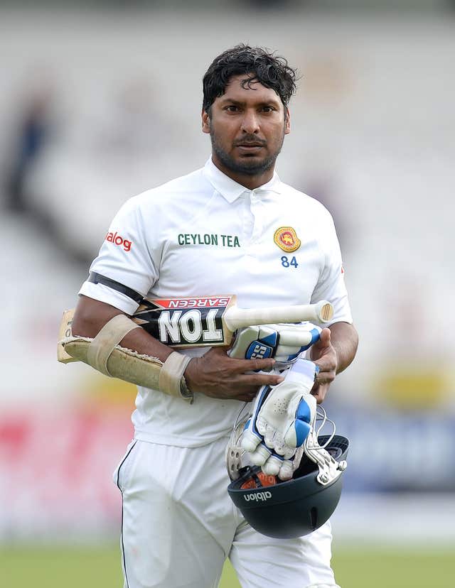 Kumar Sangakkara carries his helmet and gloves after being dismissed in a Test match against England.