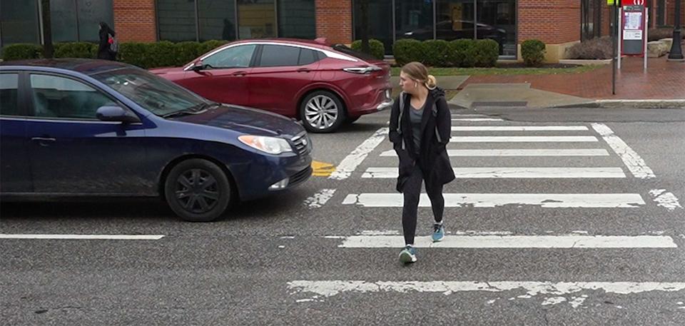 A woman walks quickly to avoid a car that did not stop for her in the crosswalk in the Ohio State University area at N. High St. and E. Frambes Avenue on Jan. 25. More than 20 pedestrians were killed on Franklin County roads in 2023.