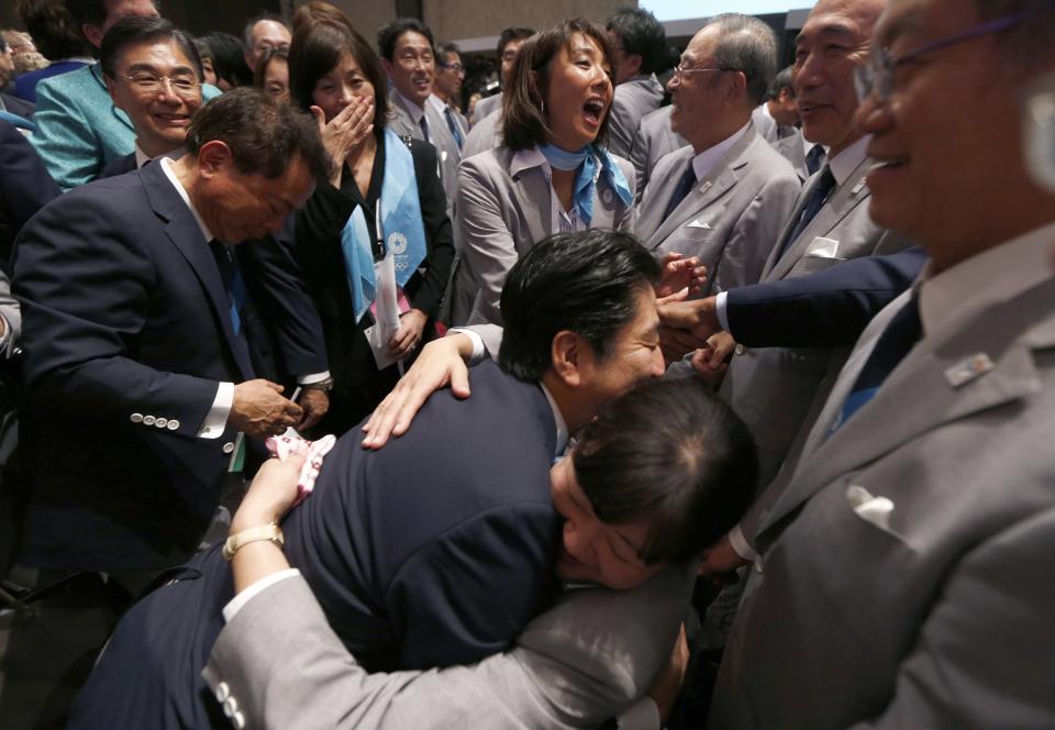 Prime Minister Shinzo Abe of Japan (C) celebrates with members of the Tokyo bid committee after Jacques Rogge, president of the International Olympic Committee (IOC), announced Tokyo as the city to host the 2020 Summer Olympic Games during a ceremony in Buenos Aires September 7, 2013. REUTERS/Marcos Brindicci (ARGENTINA - Tags: SPORT OLYMPICS POLITICS)