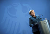 FILE - In this Sunday, March 22, 2020, file photo, German Chancellor Angela Merkel speaks at a news conference about the new coronavirus, in Berlin. World War II references are now heard daily, not because another momentous 75th anniversary, Victory in Europe Day approaches in May but because of the coronavirus. (Michael Kappeler/Pool photo via AP, File)