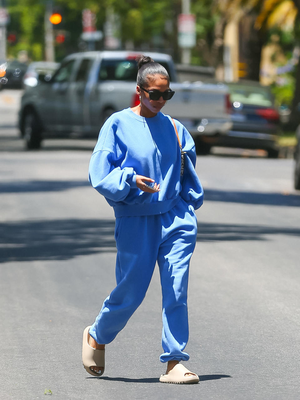 Lori in sweatpants walking down the street