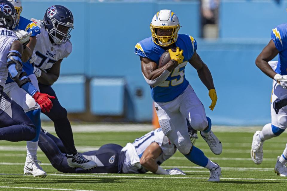 The Chargers' Joshua Kelley runs for yardage against the Tennessee Titans.