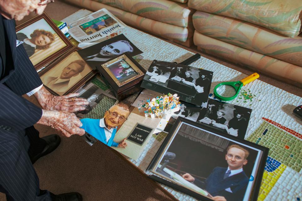 Print photo copies of Benjamin Ferencz, while he served as a prosecutor during the Nuremberg trials, on a table at his home in Delray Beach, Fla., on June 1, 2022.