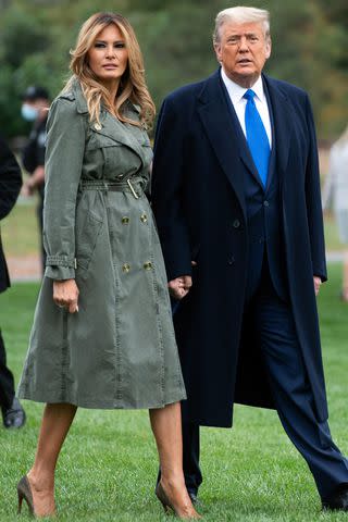 <p>SAUL LOEB/AFP via Getty</p> Then-President Donald Trump and first lady Melania Trump walk to Marine One prior to departing from the South Lawn of the White House on Oct. 27, 2020