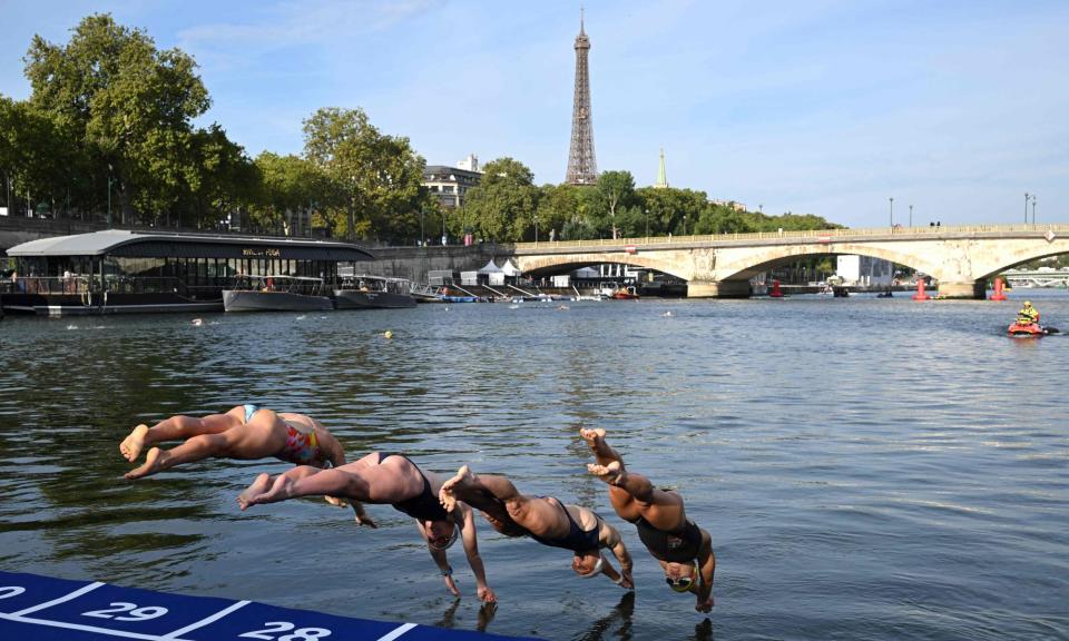 <span>Swimmers diving into the Seine last August during a river familiarisation event.</span><span>Photograph: Bertrand Guay/AFP/Getty Images</span>