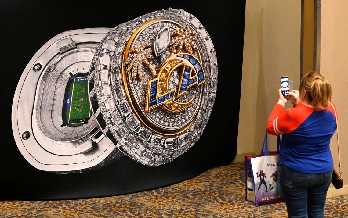 A visitor photographs an oversized image of the 2022 Los Angeles Rams Super Bowl ring at the NFL Football Experience on Friday, Feb. 10, 2023, at the Phoenix Convention Center