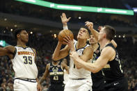 Denver Nuggets' Michael Porter Jr. looks to shoot against multiple Milwaukee Bucks defenders during the first half of an NBA basketball game Friday, Jan. 31, 2020, in Milwaukee. (AP Photo/Aaron Gash)