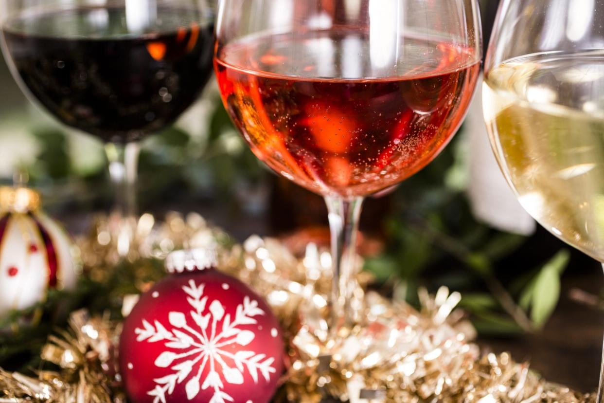 Various wines in glasses on dining table at Christmas.