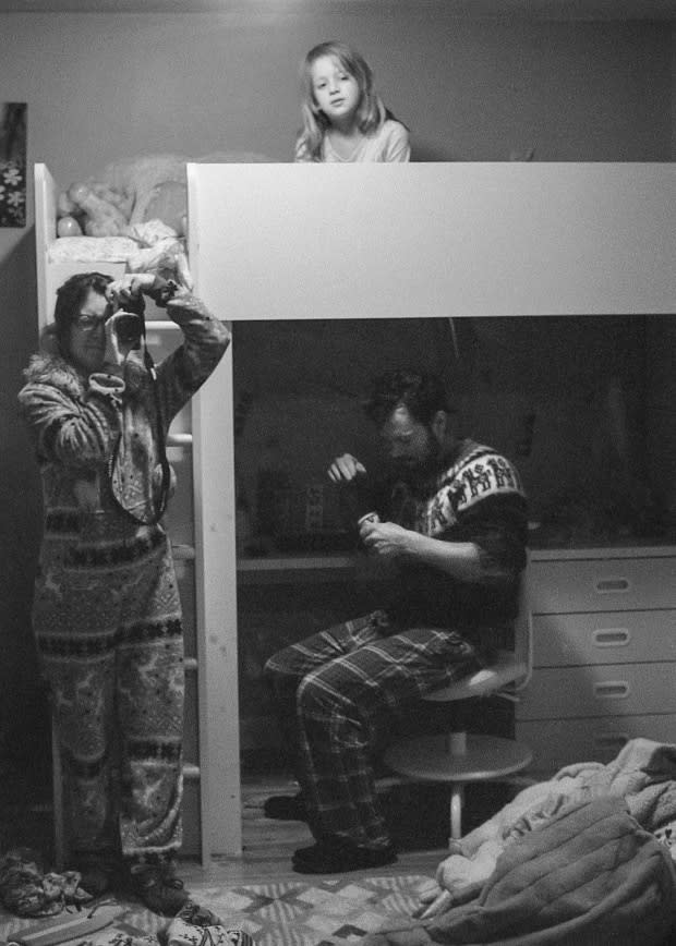 Lindsey Irene uses a mirror to capture an image of her family hunkered down at home.