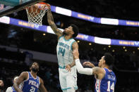 Charlotte Hornets center Nick Richards scores between Philadelphia 76ers center Joel Embiid, left, and forward Danny Green during the first half of an NBA basketball game on Monday, Dec. 6, 2021, in Charlotte, N.C. (AP Photo/Chris Carlson)