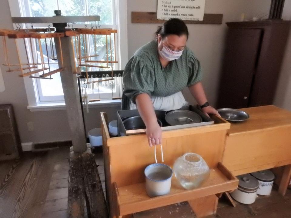 Interpreter Amy Trejo demonstrates candle making at the Hay Craft and Learning Center in Roscoe Village. While the building housed crafts and educational material before, those expanded in 2020 to better engage with visitors.