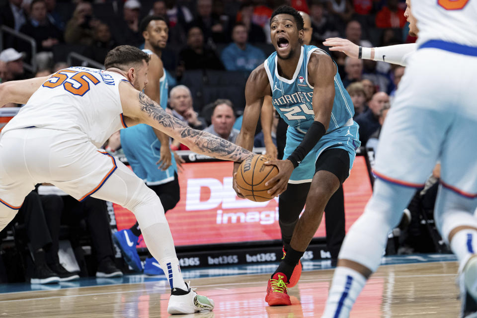 New York Knicks center Isaiah Hartenstein (55) fouls Charlotte Hornets forward Brandon Miller (24) during the first half of an NBA basketball game Monday, Jan. 29, 2024, in Charlotte, N.C. (AP Photo/Jacob Kupferman)