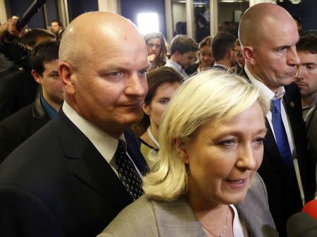 Thierry Legier (L), bodyguard for France's far-right National Front political party leader Marine Le Pen who speaks during an interview after the close of polls in France's second round Departmental elections of local councillors at their party's headquarters in Nanterre, near Paris, March 29, 2015. REUTERS/Charles Platiau/File Photo