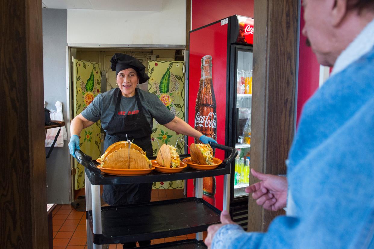 Los Alfaro’s Latin Restaurant owner Teresa Alfaro leaves the kitchen with four Footlong Tacos for tournament participants Saturday afternoon, Feb. 8, 2020. 