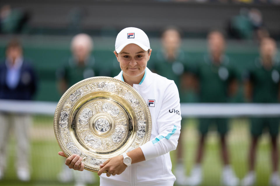 Ash Barty (pictured) smiles with the trophy after winning her maiden Wimbledon title.