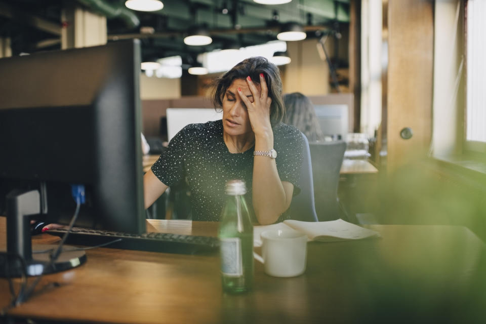 Woman feeling stressed at work. (Getty Images)