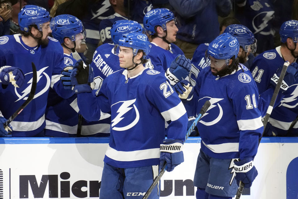 Tampa Bay Lightning center Brayden Point (21) and left wing Anthony Duclair (10) celebrate with the bench after Point scored against the Columbus Blue Jackets during the first period of an NHL hockey game Tuesday, April 9, 2024, in Tampa, Fla. (AP Photo/Chris O'Meara)
