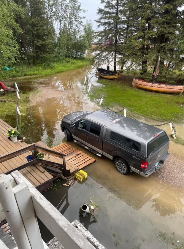 Jane Groenewegen says flooding on her guest house property on Vale Island in Hay River, N.W.T. is the worst she's seen in more than 35 years of operation — and she's stopped taking guests as a result. (Submitted by Jane Groenewegen - image credit)