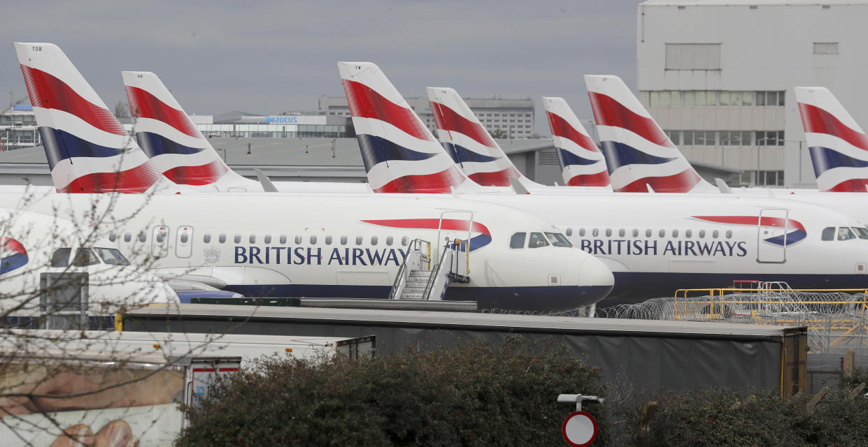 British Airways planes parked at Terminal 5 Heathrow airport in London, Wednesday, March 18, 2020. Britain's Foreign Secretary Dominic Raab has taken the decision to advise British nationals against non-essential travel globally for an initial period of 30 days, and of course subject to ongoing review. For most people, the new coronavirus causes only mild or moderate symptoms, such as fever and cough. For some, especially older adults and people with existing health problems, it can cause more severe illness, including pneumonia. (AP Photo/Frank Augstein)