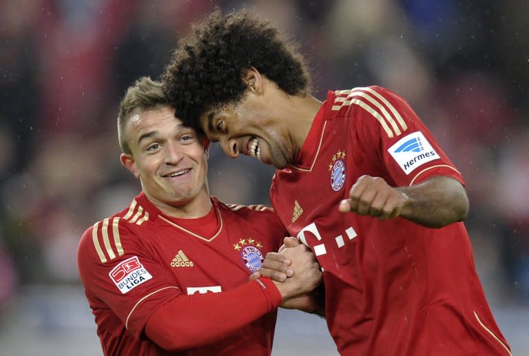 Bayern Munich defender Dante (R) and midfielder Xherdan Shaqiri celebrate beating Stuttgart 2-0 in the Bundesliga on January 27, 2013. After an unimpressive first-half display, Bayern roared back with Croatia striker Mario Mandzukic capitalising on a mistake in the Stuttgart defence for the first goal before setting up Thomas Mueller for the second