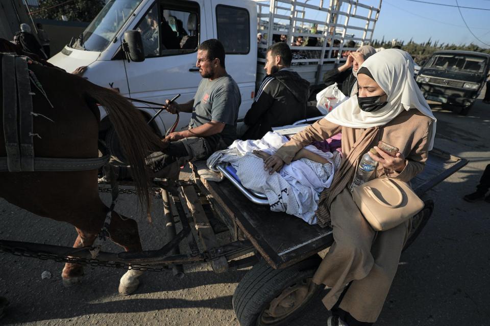Palestinians flee Gaza City carrying their sick sister on Nov. 18, 2023. <a href="https://www.gettyimages.com/detail/news-photo/palestinians-flee-gaza-city-carrying-their-sick-sister-news-photo/1790171061?adppopup=true" rel="nofollow noopener" target="_blank" data-ylk="slk:Loay Ayyoub/For The Washington Post via Getty Images;elm:context_link;itc:0;sec:content-canvas" class="link ">Loay Ayyoub/For The Washington Post via Getty Images</a>