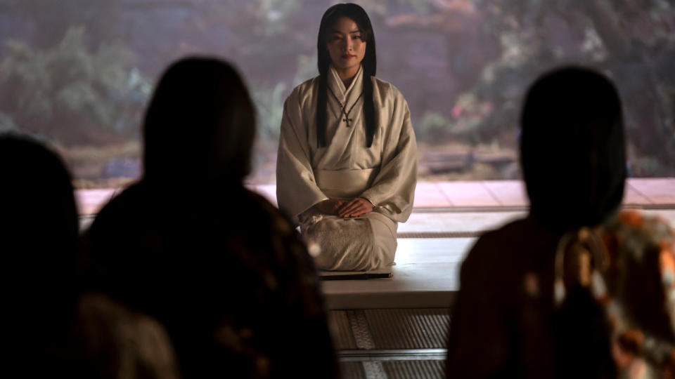 Anna Sawai kneels in front of a crowd in Shōgun.