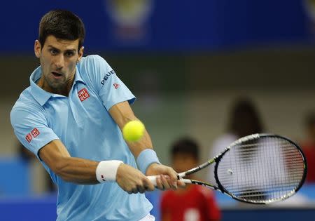 UAE Royals' Novak Djokovic of Serbia hits a return to Indian Aces' Gael Monfis of France during their match at the International Premier Tennis League (IPTL) in Dubai December 13, 2014. REUTERS/Ahmed Jadallah