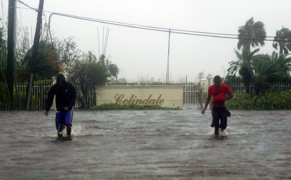 Residents wade through a street flooded with water brought on by Hurricane Dorian in Freeport, Bahamas, Sept. 3, 2019. (Photo: Ramon Espinosa/AP)